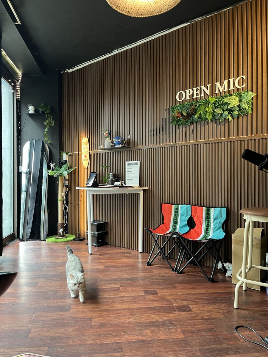 오픈믹 스튜디오 내부, OPEN MIC 로고 벽과 라탄 조명